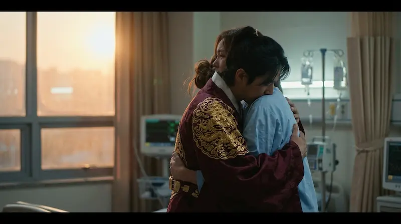 A man in royal clothing tearfully embracing a woman in a hospital, reflecting the song Our Goodbye