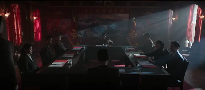 The Espionage Layer Widens the Story North Korean State Security Bureau meeting room scene introducing espionage layer in Agent Kim Reactivated Episode 2 Netflix