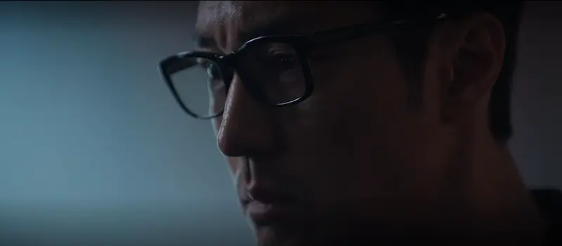 The Man Behind the Glasses — Kim Bujang's True Identity So Ji-sub as Kim Bujang revealing hidden black ops past intensity in Agent Kim Reactivated Netflix action thriller closeup